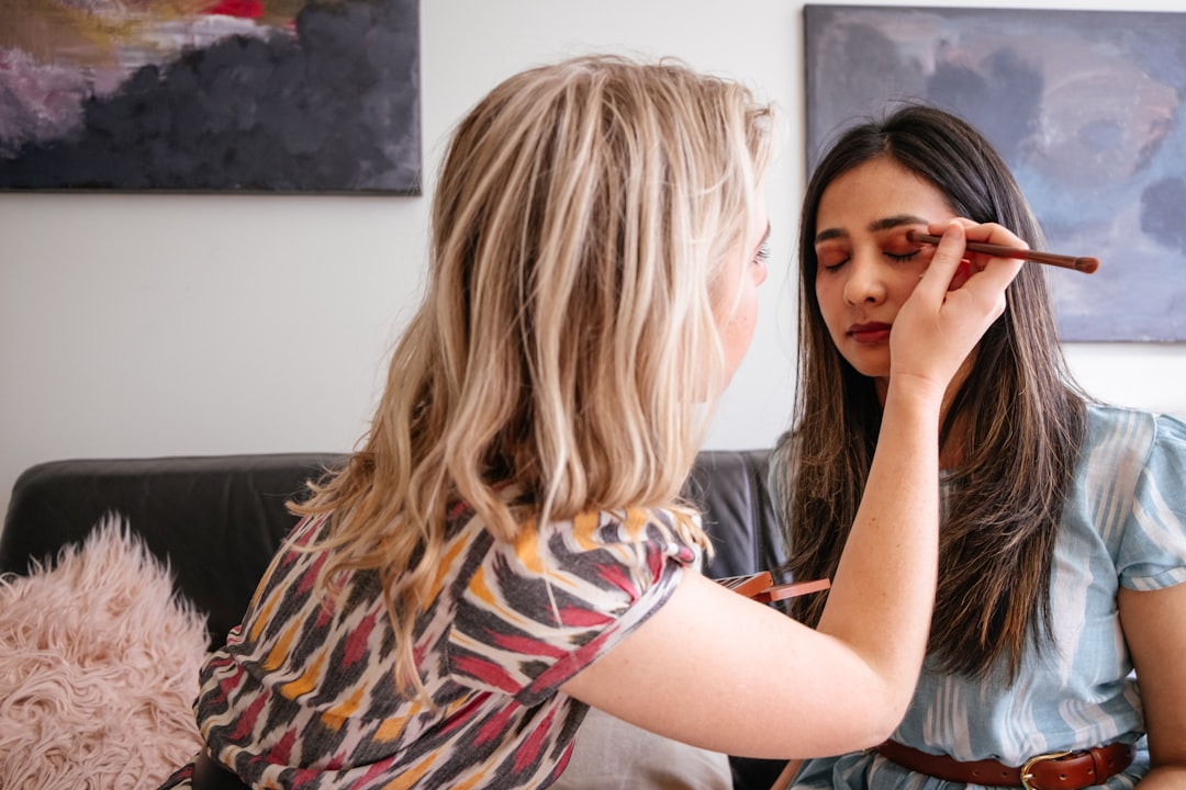 A close-up of a person applying makeup to contour their face, showcasing the tools and techniques used for a natural look.